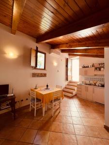 a kitchen with a table and chairs in a room at JP House Amalfi in Amalfi +30 photos