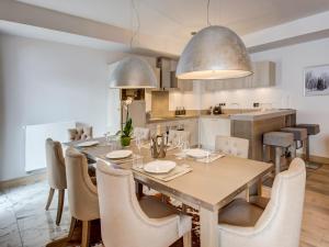 a kitchen and dining room with a table and chairs at Appartement Courchevel 1550, 4 pièces, 6 personnes - FR-1-562-34 in Courchevel