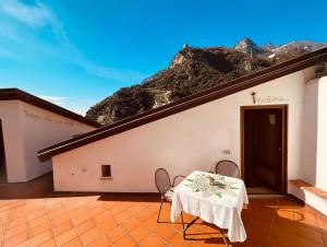 a table and chairs on a patio with a mountain at JP House Amalfi in Amalfi