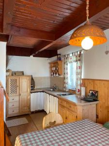 a kitchen with a table and a table and a light at Apartma Tisa in Zreče