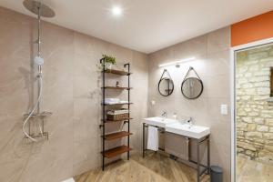 a bathroom with a sink and a shower at Gite La Petite Ferme in Clermont-les-Fermes
