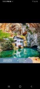 a picture of a building next to a river at Apartman Maida in Blagaj