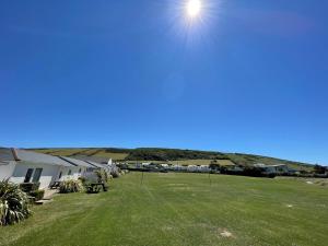 a large yard with a picnic table and houses at Croyde Bay Hotel or Self Catering in Croyde