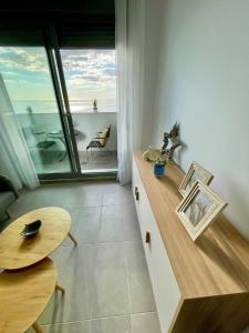 a room with a counter and a table and a view of the ocean at GATU Villa Camarote con vistas al mar in Cádiz
