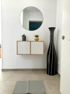 a room with a mirror and a vase and a rug at GATU Villa Camarote con vistas al mar in Cádiz
