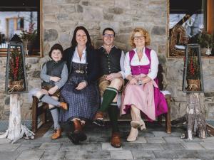 a group of people sitting on a bench at Appartements Liebe Heimat in Saalbach Hinterglemm