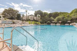 a large pool with blue water in a resort at La Manga Club Resort - Bellaluz 4 in Atamaría