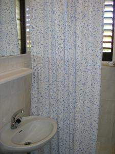 a bathroom with a sink and a shower curtain at Villa Jadranka in Hvar
