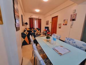 a living room with a blue table and chairs at Legarse Staycation at Montecito Residential Resort in Manila