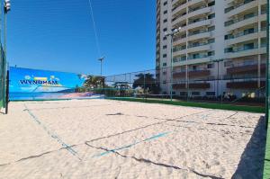 a volleyball court in front of a building at Wyndham Olímpia Royal Hotels in Olímpia