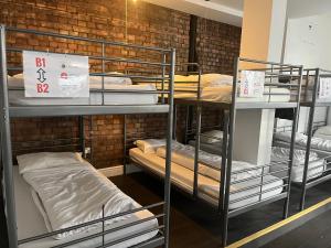 a room with several bunk beds in a room at The Walrus Bar and Hostel in London