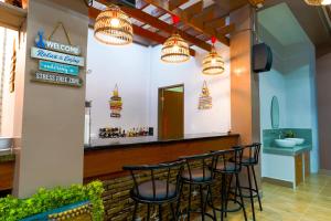 a bar with black stools in a restaurant at MS Mountain Cabin in Loboc