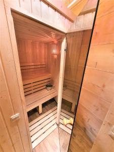 uma sauna de madeira com uma porta de vidro num quarto em Zasypane Premium House & Sauna in Zakopane by Renters Prestige em Zakopane