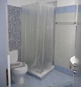 a bathroom with a shower with a toilet and a sink at Porto View Suites and Apartments in Porto Heli