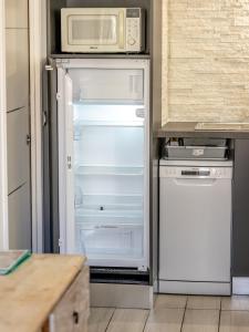 an open refrigerator in a kitchen with a microwave at Guest House Maccarani in Nice