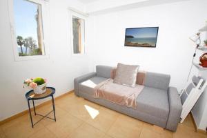 a living room with a couch and a table at Wind Rose Study Xàbia in Jávea