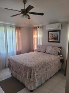 a bedroom with a bed and a ceiling fan at Debra's Place Lot 147 in Priory