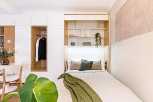 a bedroom with a bed and a chair and a table at TurnKey I Studio by Amazing Park in Prague