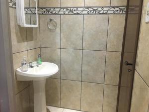 a bathroom with a sink and a shower at Pousada La Marea in Rio Grande