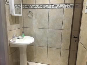 a bathroom with a sink and a shower at Pousada La Marea in Rio Grande +63 photos