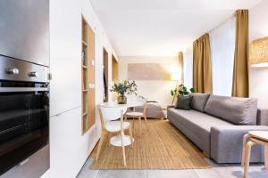 a living room with a couch and a table at TurnKey I Studio by Amazing Park in Prague +4 photos