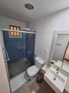 a bathroom with a toilet and a shower and a sink at Sertão Veredas Hotel Fazenda in Paraopeba