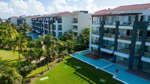 an aerial view of a resort with palm trees at Stunning Ocean Front By Condo Boutique in Playa del Carmen
