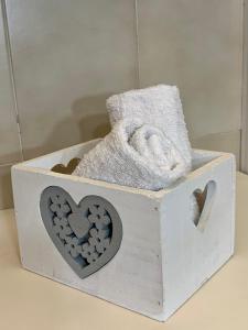 a wooden box with hearts and towels on a table at CasaTosca in Chianciano Terme