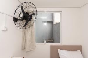 a fan hanging from a wall next to a window at Apto Bela Vista São Paulo in Sao Paulo +245 photos