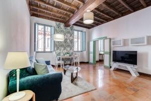 a living room with a couch and a tv at The Unique Home Pantheon in Rome