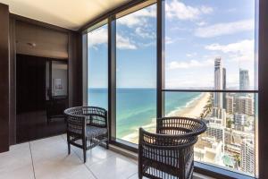 a balcony with chairs and a view of the ocean at Sea view Beachfront apartment in surfers in Gold Coast