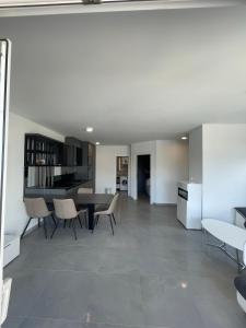 a dining room and living room with a table and chairs at Villa Omazic in Trogir