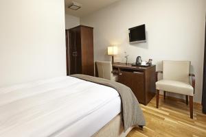 Ένα ή περισσότερα κρεβάτια σε δωμάτιο στο Hotel Kea by Keahotels