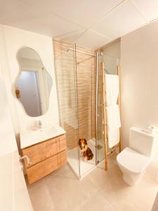 a bathroom with a shower and a dog laying on the floor at La casa de Lola in Motril