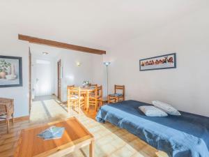 a bedroom with a bed and a table and a dining room at Holiday Home Bonporteau-3 by Interhome in Cavalaire-sur-Mer