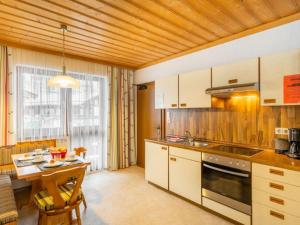 a kitchen with wooden walls and a wooden ceiling at Apartment Vorreiter - UTD150 by Interhome in Uttendorf