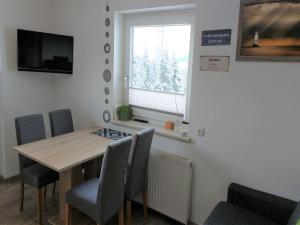 a dining room with a table and chairs and a window at Apartment Tobias 1 by Interhome in Radstadt +20 photos