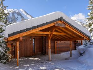 a log cabin with snow on top of it at Chalet Voltaire by Interhome in Ovronnaz