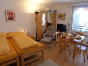 a bedroom with a bed and a table and a desk at Apartment Cransalpin Apt- 3 - Secteur 1 by Interhome in Vermala