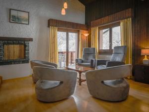 a living room with chairs and a table at Apartment Jorasse C 20 by Interhome in Ovronnaz