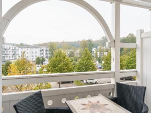 a balcony with an arched window and a table and chairs at Apartment Seepark Sellin-2 by Interhome in Ostseebad Sellin