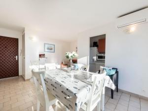 a white dining room with a white table and chairs at Apartment Les Jardins del Mar-2 by Interhome in Cavalaire-sur-Mer +20 photos