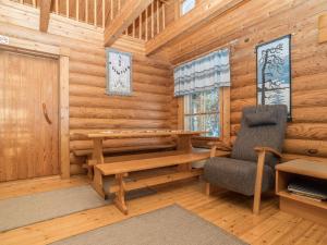 a log cabin with a desk and a chair at Holiday Home Ruka-kitkan lomamajat-varpunen by Interhome in Säkkilänvaara