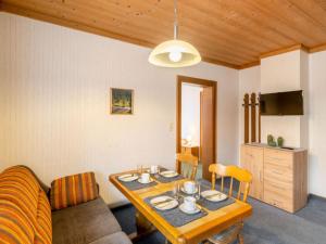 a living room with a table and a couch at Apartment Vorreiter-1 by Interhome in Uttendorf