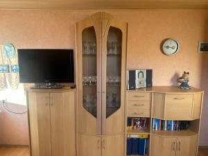 a large wooden entertainment center with a flat screen tv at Apartment Bentweg by Interhome in Altgaude