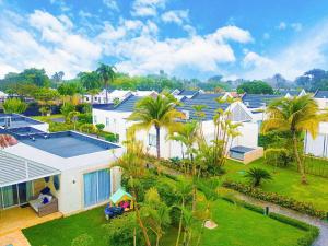 an aerial view of a house with palm trees at Playa Dorada Suites in San Felipe de Puerto Plata