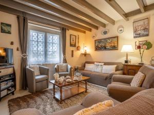 a living room with a couch and a table at Holiday Home Saint Ideuc by Interhome in Saint Malo