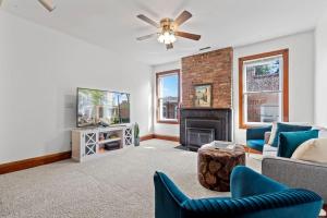 a living room with a couch and a tv at Spacious Home in Heart of Historic Fan District in Richmond