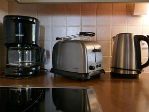 a toaster and coffee maker on a kitchen counter at Apartment Chalet Albi-2 by Interhome in Grindelwald +29 photos