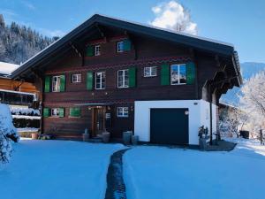 a house with a garage in the snow at Apartment Träumli by Interhome in Lenk